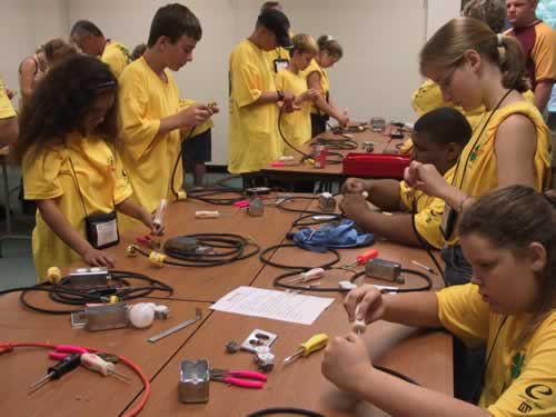 Students learning about electricity in camp