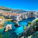 A view of the beautiful scenery of Dubrovnik, Croatia, with hills, buildings and water running through the center.