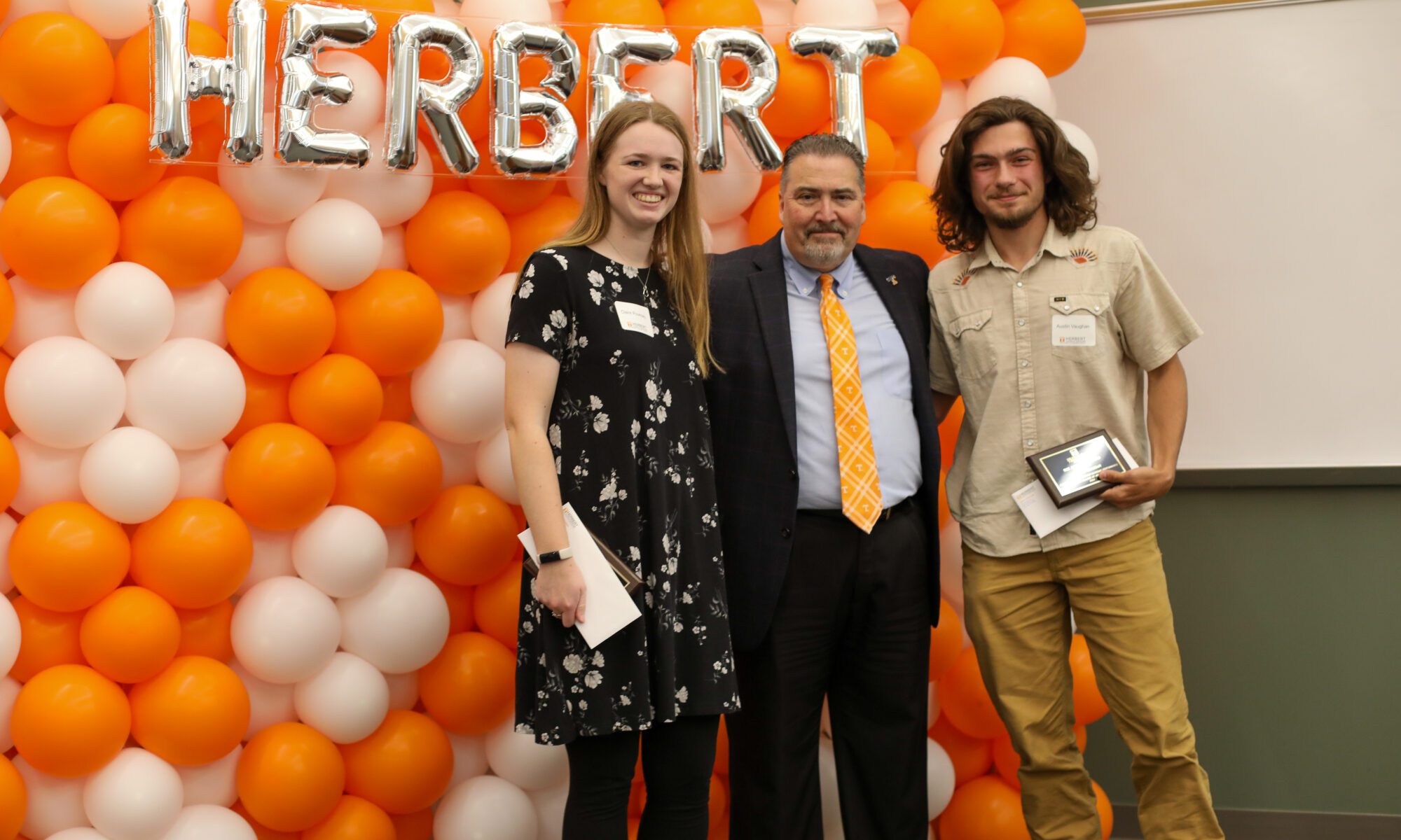 Claire Pouncey and William Vaughn, winners of the Armistead Award, stand with Dr. David White at the 2024 Herbert Award Ceremony