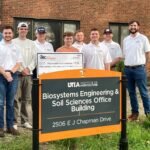 Construction Science students standing behind BESS sign holding a check from ABC Workforce Competition