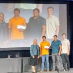 Dr. Dana Porter with Aaron Eimers, Julian Lee and Will Carey, who are being handed their prize at the 2024 ASABE conference