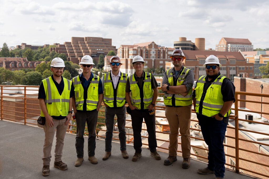 Construction science alumni standing on campus